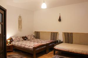 a living room with two beds and a couch at Casa Kővár Vendégház in Rimetea