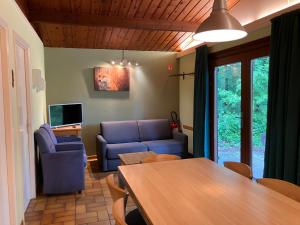 a living room with a couch and a table at Le Renard - Oignies 50 in Petit Mesnil