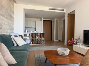 a living room with a green couch and a table at Dukley residence Lux in Budva