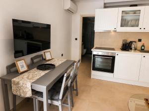 a kitchen with a table with chairs and a microwave at Seaside Nest in Kythira