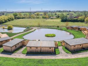 an aerial view of a farm with a pond and buildings at Hummingbird Lodge - Uk51940 in Yarm