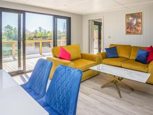 a living room with two couches and a table at Hummingbird Lodge - Uk51940 in Yarm