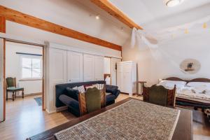 a living room with a bed and a couch at KUL App 6 by Alpenidyll Apartments in Öblarn