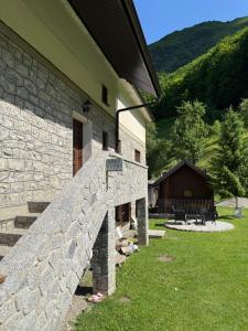 a stone oven on the side of a building at Guest House Vuthaj in Vusanje