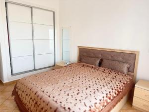 a bedroom with a bed and a large window at Apartment inside a apartment complex by the beach with public pool in Marina Smir +11 photos
