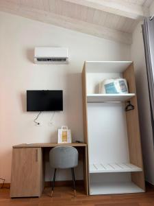 an office with a desk and a tv and a shelf at Domos de Budroni B&B in Bono
