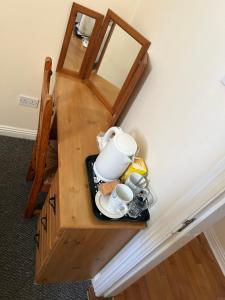 a table with a tray with cups and a mirror at The pillar in Wexford