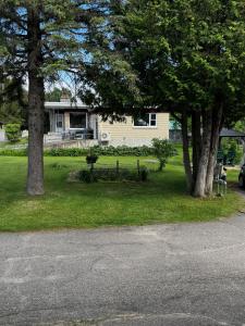 a house with two trees in front of it at Le Petit Saint-Joseph in Saint-Alexis-des-Monts