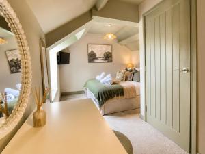 a bedroom with a bed and a table in a room at Lilac Cottage in Barnard Castle +31 photos