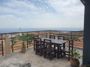 a table and chairs on a balcony with the ocean at la sublime in Taghazout