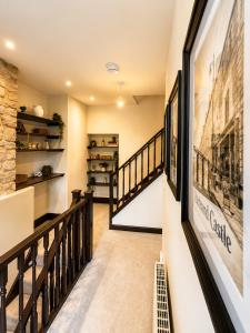 a staircase in a house with pictures on the walls at Lilac Cottage in Barnard Castle