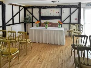 a room with a table and chairs with vases on it at Duvale Priory - 9985 in Bampton