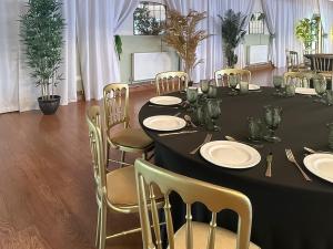 a black table with chairs and plates on it at Duvale Priory - 9985 in Bampton
