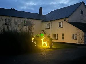a fire hydrant in front of a house at night at Duvale Priory - 9985 in Bampton