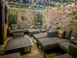 a patio with couches and a table and lights at Duvale Priory - 9985 in Bampton +50 photos