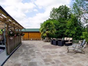 a patio with chairs and a fence and trees at Maple - Uk46284 in Camerton