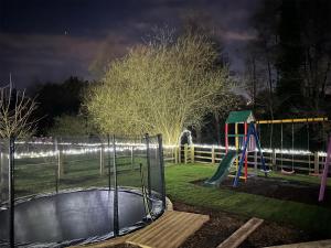 a park at night with a playground and a slide at Apple-Uk46285 in Camerton