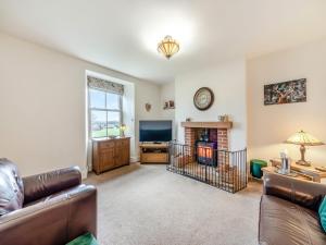 a living room with a couch and a television at Binchester Crag Farm in Bishop Auckland