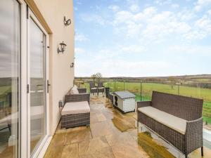 a balcony with chairs and a view of a field at Binchester Crag Farm in Bishop Auckland