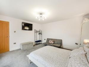 a white bedroom with a bed and a chair at Binchester Crag Farm in Bishop Auckland +19 photos
