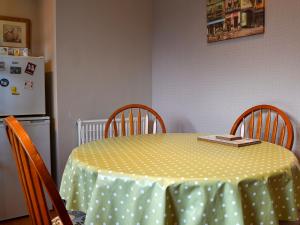 a table with a green and white polka dot table cloth at Brae Lodge in Cullen