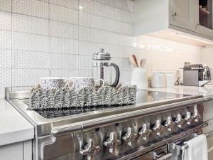 a drying rack sitting on the stove in a kitchen at Cross Keys Cottage in Skipton