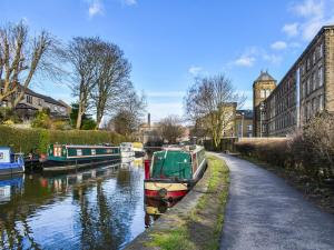 a couple of boats are docked on a canal at Cross Keys Cottage in Skipton +39 photos