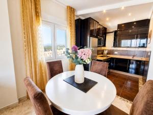a white table with a vase of flowers on it at Algaida, beach apartment in Mijas Costa +36 photos