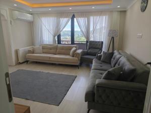a living room with a couch and two chairs at Sama house in Rize