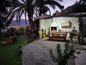 a backyard with a fireplace and a table and chairs at Anna's sea view apartment in Kánithos