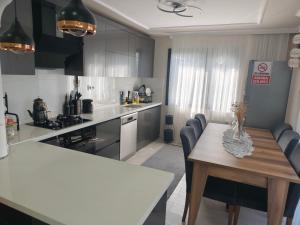 a kitchen with a table and chairs in a kitchen at Sama house in Rize