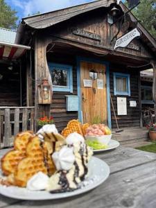 two plates of food on a table in front of a building at Lillstugan in Sälen