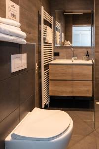 a bathroom with a toilet and a sink at De Watersport Heeg in Heeg +74 photos