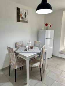a dining room table with chairs and a refrigerator at La casa di Stella in Isernia