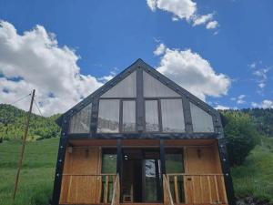 a house with glass windows on the side of it at Tsiskari in Tsaldashi +24 photos