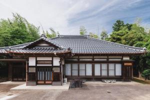 an asian style house with a roof at Irest Village Narita in Narita