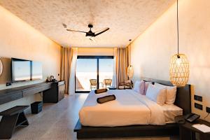 a bedroom with a large bed and a television at Sentido Naga Bay - adults friendly in Hurghada +104 photos