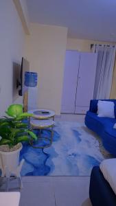 a living room with a couch and a table at BREE'S EXECUTIVE STAYs in Kakamega