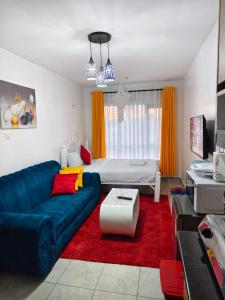 a living room with a couch and a bed at GCurtway Homes Tsavo Superior Studios in Nairobi