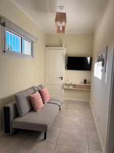 a living room with a couch and a flat screen tv at Punto San Martin in Venado Tuerto