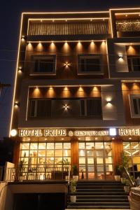 a hotel with lights on the front of a building at hotel pride & restaurant in Dabok
