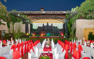 a long table with red and white chairs in front of a building at Hotel Somadevi Angkor Resort & Spa in Siem Reap +66 photos