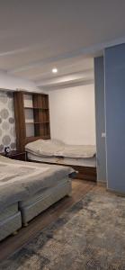 a bedroom with two beds in a room at Иссык-Куль in Tossor
