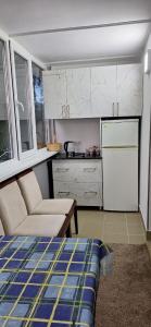 a kitchen with a couch and a white refrigerator at Иссык-Куль in Tossor