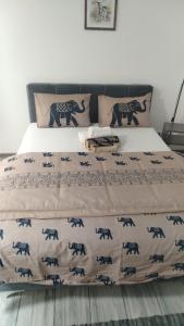a bedroom with a bed with an elephant blanket at City Nest in Vršac