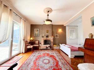 a living room with a bed and a fireplace at Villa Terrazza in Donji Morinj
