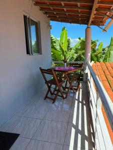 a balcony with a table and chairs on it at Suite em Mulungu in Mulungu