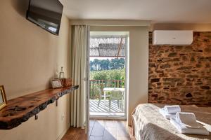 a room with a bed and a sliding glass door at Quinta Da Estrada Winery Douro Valley in Peso da Régua