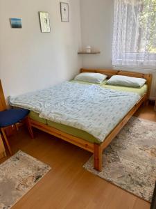 a bed in a room with two pillows on it at Johanna Balatoni Ház in Balatonfenyves +24 photos
