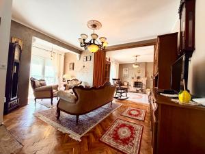 a living room with a chair and a couch at Villa Terrazza in Donji Morinj
